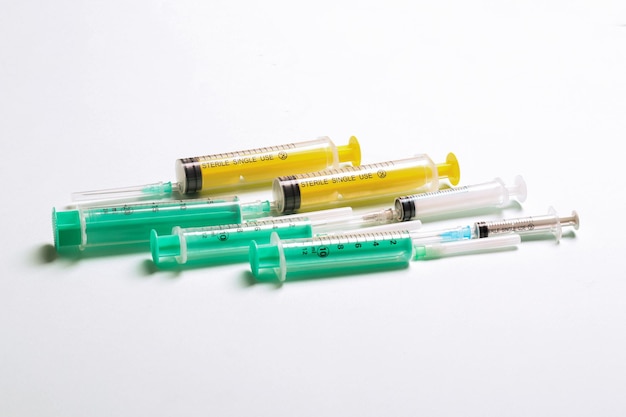 Top view of different syringes at blue background Medical injection concept with copy space