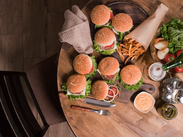 Top view of different tasty burgers with vegetables. Garlic sauce. Fresh lunch.