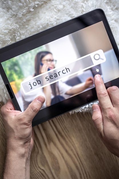 Top view of digital tablet with search job on screen in male hands
