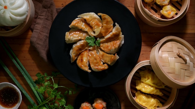 Top view of Dim sum with Gyoza, dumplings and bun served on traditional steamer