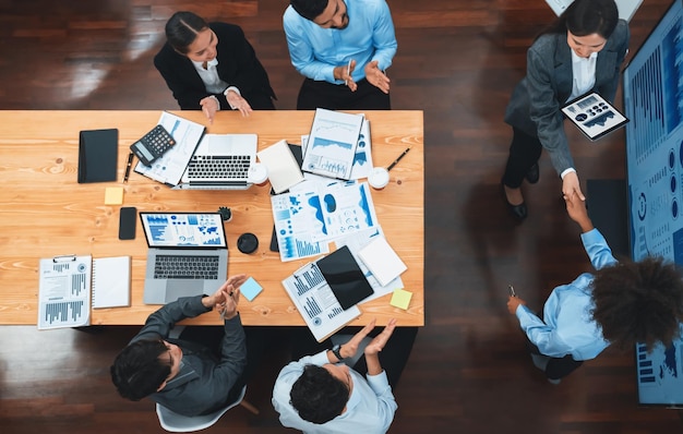 Top view diverse coworkers celebrate success with handshake Concord