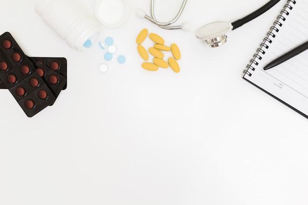 Top view of doctor's desk table, blank paper on white