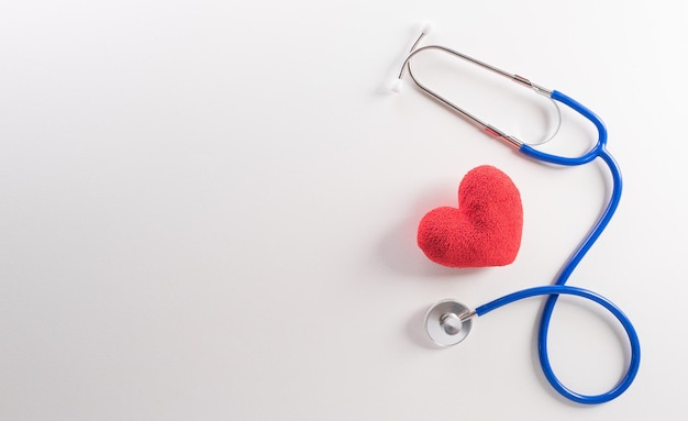 Top view of doctor stethoscope and red heart on white background International nurse day and medical concept