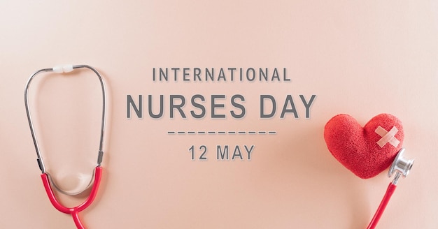 Photo top view of doctor stethoscope and red heart with the text on pastel background international nurse day and medical concept