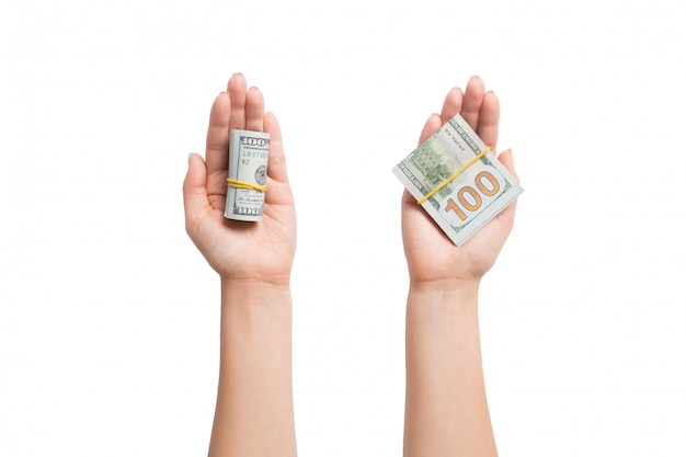 Top view of dollar bills in tubes in female hands on white