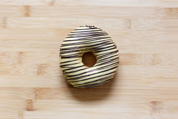 Top view of donut on the wooden table.