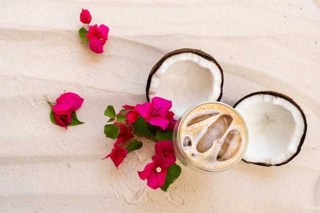 Top View double glass latte on sand beach background.