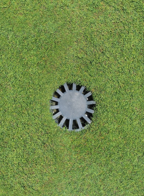 Top view of drain on soccer field with copy space.