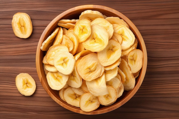 Top view of dried banana chips in wooden bowl isolated on white background Full depth of field Flat