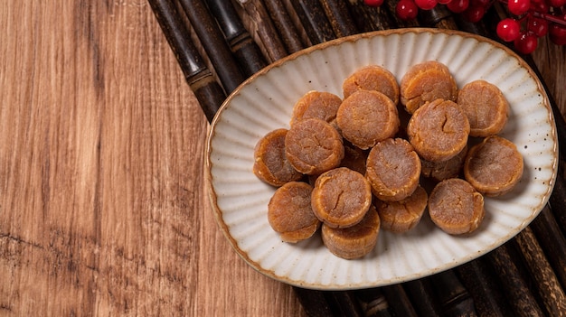 Top view of Dried scallop on wooden table for Chinese lunar new year boxed gift.