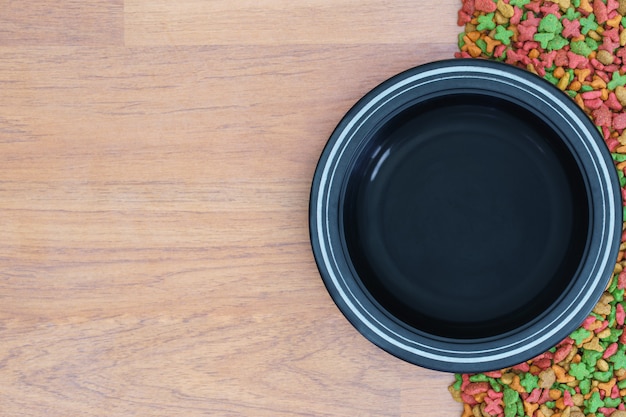 Top view dry food for cat and dog with empty bowl