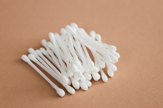 Top view of ear sticks on beige background with copy space