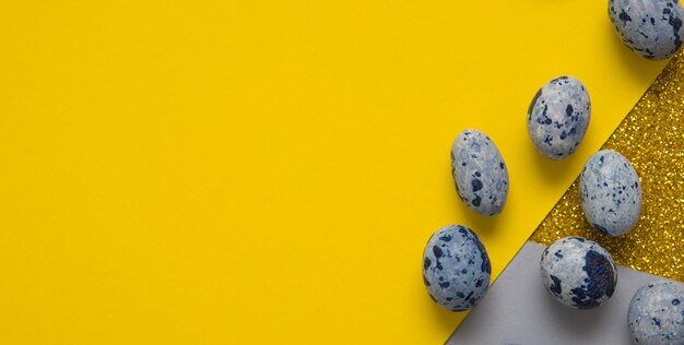 Top view of easter eggs in rhinestones and sequins on paper