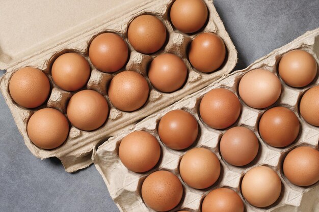 Top view of eggs in a cardboard box ready for breakfast