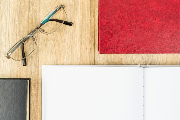 Top view empty blank notebook diary and eye glasses