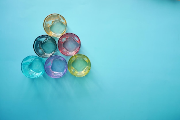 Top view of empty drinking glasses on blue background