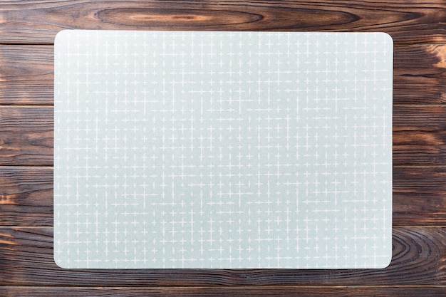 Top view of empty green table napkin for dinner on wooden