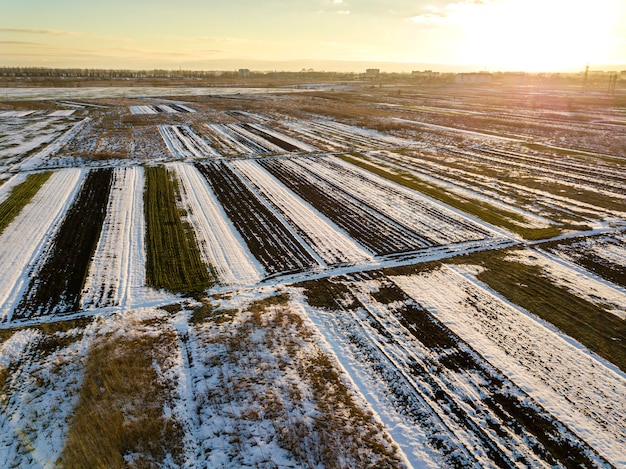 Top view of empty snowy fields patched landscape