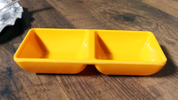 Top view empty yellow bowl on rustic wooden table