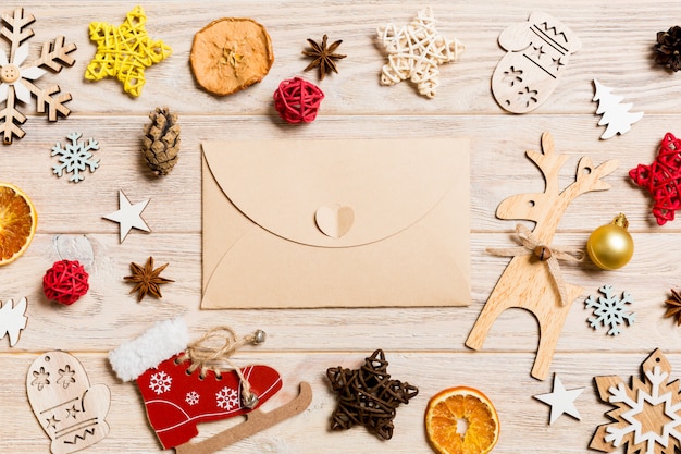 Top view envelope on festive wooden . Christmas toys and decorations.   time 