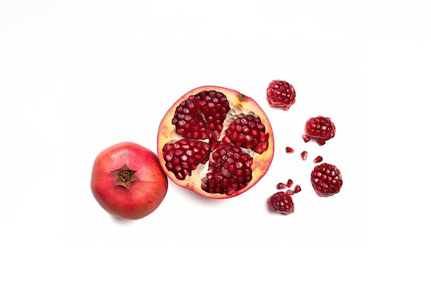 Top view exotic and delicious whole and part of pomegranate on white background