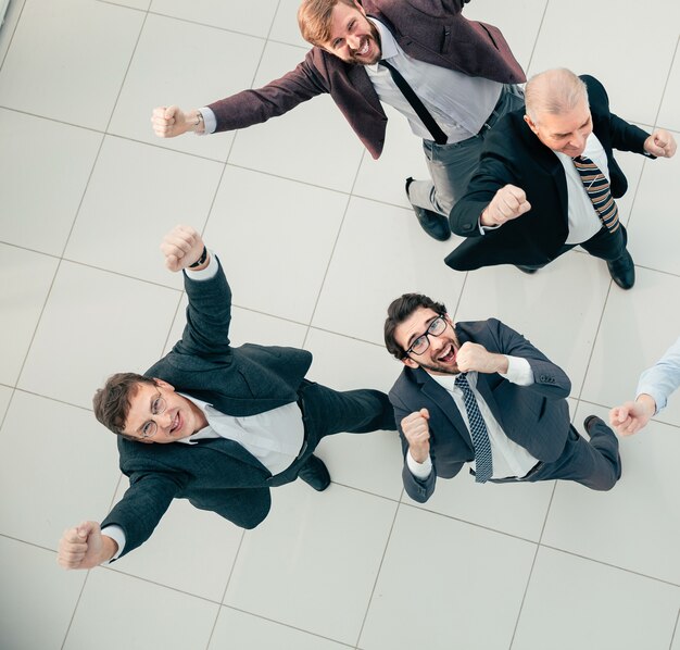 Top view. exultant business team standing in the office. photo with a copy-space.