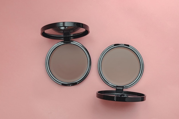 Photo top view eye shadow blush powder sculptor in a case pink isolated background place for text aestheti