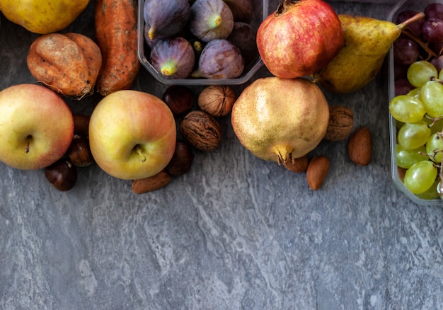 Top view of fall fruits over grey surface