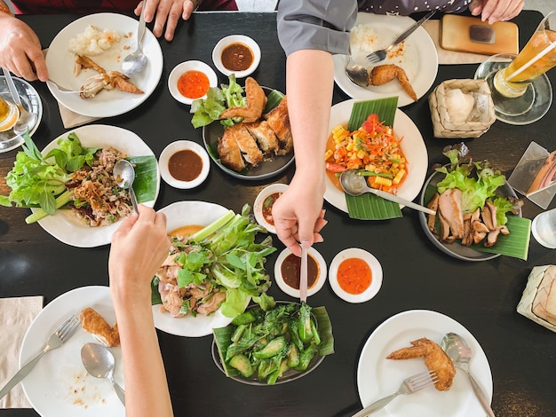 Top view of family eating food together at lunch time