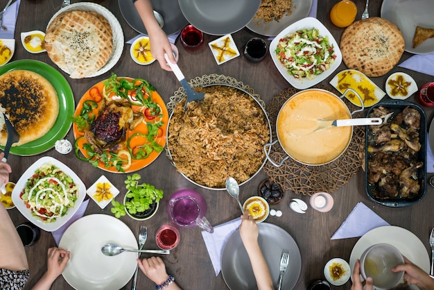 Top view of family and friends eating food on table