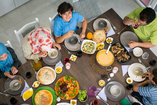 Top view of family and friends eating food on table