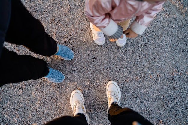 Top view of family legs on the ground outdoors. Bonding time together. Simple things. High quality photo