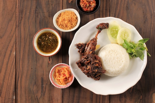 Top View Famous Food in Madura, Indonesia Called "Bebek Sinjay", Bebek is Duck, Consisting of Rice, Duck, Cucumber, Basil and Young Mango Chilli