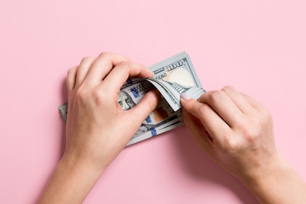 Top view of female hands counting money