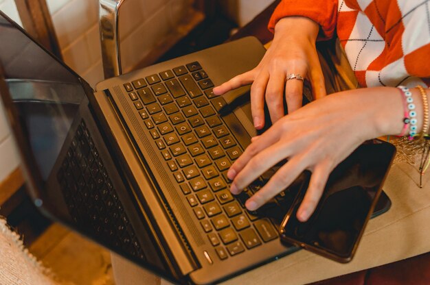 top view female hands typing on laptop keyboard focus on keyboard