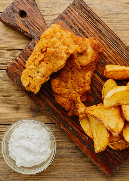 Top view of fish and chips with sauce