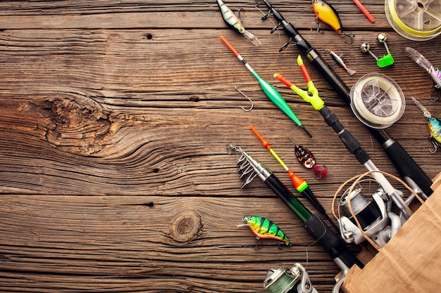 Photo top view of fishing essentials in paper bag with copy space