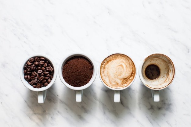 Top view five cups of different stages of preparing cappuccino with copy space