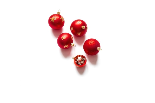 Photo top view of five red christmas balls isolated on white background