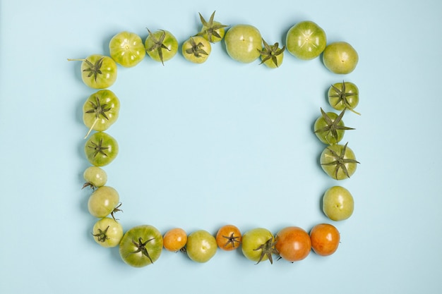 .Top view, flat lay of fresh green tomatoes in different sizes frame