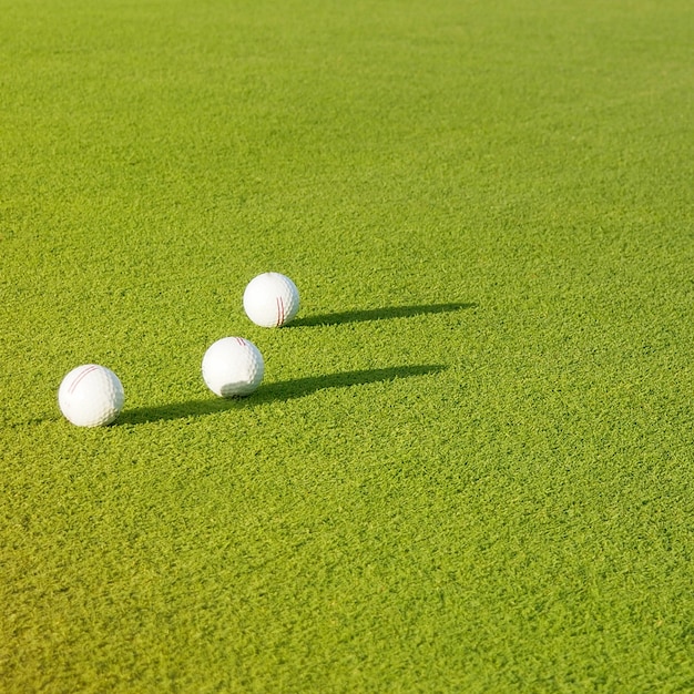 top view flat lay of golf balls on grass background.