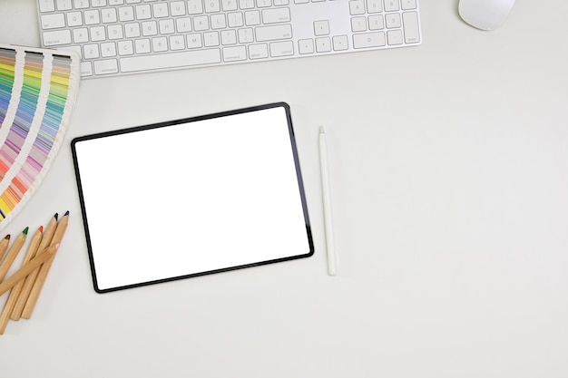 Top view flat lay of minimal workspace on white table background with digital tablet mockup