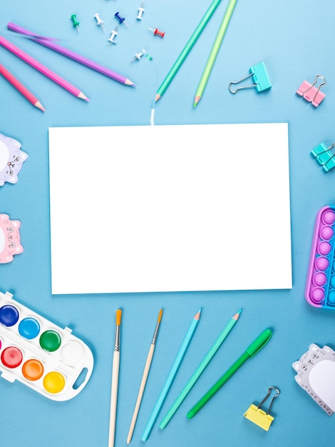 Top view of a flat work desk lies a notebook with blank sheets and stationery Template for women's blogs in social networks