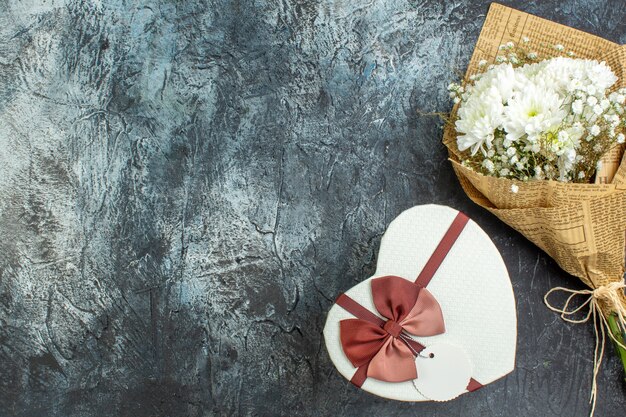 top view flower bouquet heart shaped box on dark background copy place