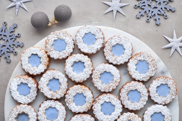 Top view of flower Linzer cookies with blue glazing