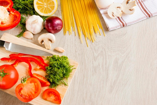 Top view of food vegetables fruits greens mushrooms on a light wooden background