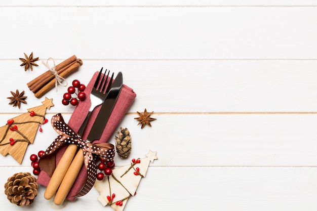 Top view of fork and knife tied up with ribbon on napkin