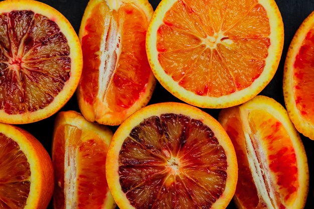 Top view of fresh blood orange halves and quaters. Fruit wall.