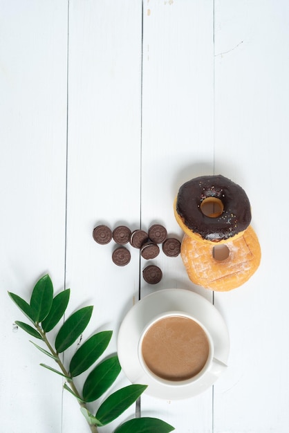 Top view of fresh bread and coffeeFern leafmonstera leaf separate on a white background wood