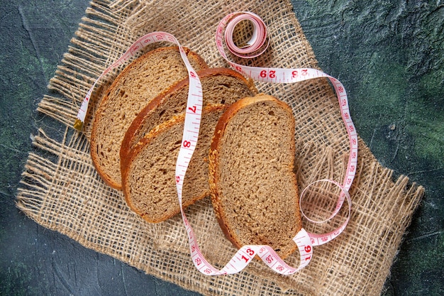 Top view fresh bread loafs on dark desk